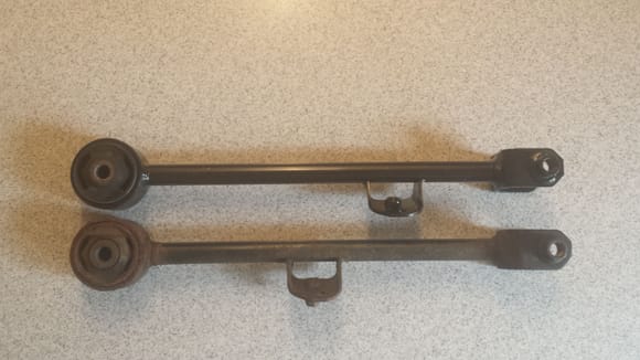 '99 Acura TL OEM Trailing Arm (Bottom) and aftermarket replacement Trailing Arm (Top).

I can't find replacement Trailing Arms with parking Brake Cable Brackets in same location.