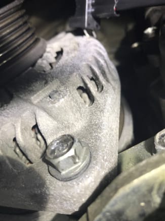 Remove this bolt on the left of the alternator.