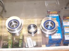 Stock Typhoon bearing carriers machined out to hold twin row bearings for a 400ex. The bearing in the center is the stock one in the Typhoon.