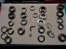 Headset parts with a couple of loose items that came with them.  About six of the race assemblies will go to the chrome platers for restoration.  It will drive the cost up a bit but they will be correct and pretty shiny when done.