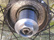 The tool fits onto the spindle mating with the flats on the end cap and the nuts locks it in place. Remember to keep slackening the hub bearings and the tool securing nut as the end cap is unscrewed.