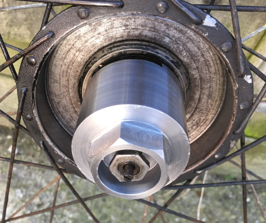 The tool fits onto the spindle mating with the flats on the end cap and the nuts locks it in place. Remember to keep slackening the hub bearings and the tool securing nut as the end cap is unscrewed.