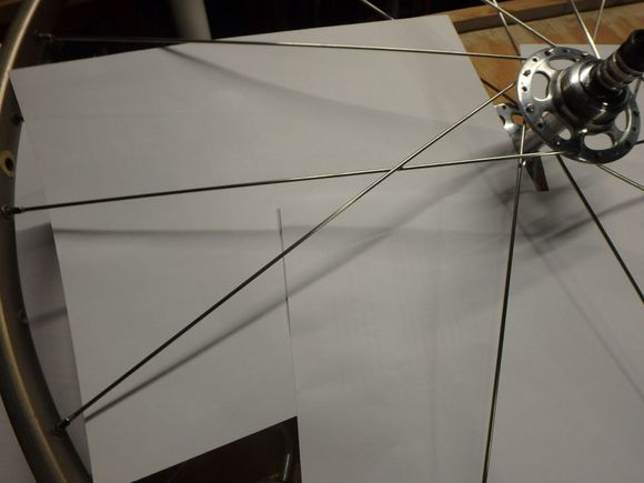 The nipple is installed with the outside flange spoke located two holes from the inside flange spokes.