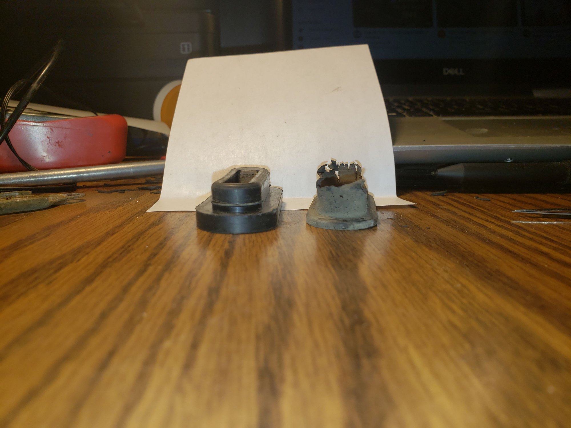End view of new, unmodified seal and old one. The base of the new one needs to be narrowed and made less tall. I used a set of small scissors to do it.