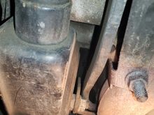 View of the backside of the power steering pump. There was a fitting that was hard to reach on the back side.