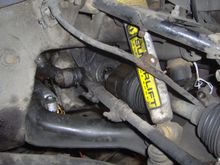 Drive axle partially removed before I realized I would have to also remove the steering knuckle to get it out.