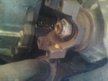 this is a view of the yoke on the front differential notice the 4 holes that hold on front driveshaft yoke these bolts are 11mm and may require some persuasion to bust loose