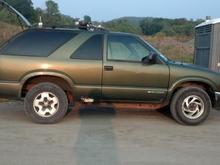 Original size tires, original wheel in back, spare on front.