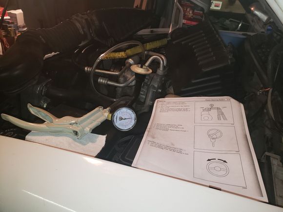 Evacuating the power steering reservoir with the Mity-Vac.