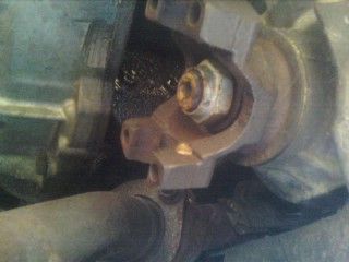 this is a view of the yoke on the front differential notice the 4 holes that hold on front driveshaft yoke these bolts are 11mm and may require some persuasion to bust loose