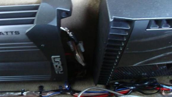 fusion 900 watt amp for my door speakers on left, rockford 1001 bd amp to the right for my XD's. Both mounted to the back of the rear seats (cant fold em down anymore but oh well)