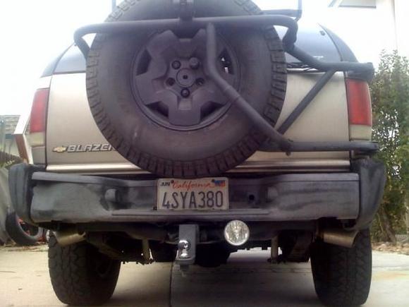 spintech dual exhaust custom built by me with double wall stainless steel tips. custom bike rack mounted to rear spare tire mount and rear spare tire moved down 3 inches for better view out of the back window. 4.5 inch round fog light mounted below bumper for better view while reversing in the dark.... custom dent on drivers side bumper!