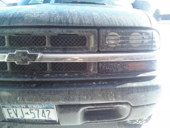 Note: I am an experienced painter. I do not recommend just picking up a can of paint and having your fun because it is a highly invasive process in which many variables are considered. Controlled enviornment/safety, correct materials, maticulous application/rendering and correct dry time.

---dirty front grill before the stripe painting. I had old head light black outs but after loosing one i decided to paint them. I took precautions with this because I like for other drivers to see me. Made sure most of the light would come thru before painting. Two step masking process with my own design.
