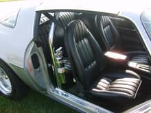 inside...pretty much stock with a 4 point chrome roll bar and two chrome fire extinguishers. Factory gauges. Kenwood two knob radio and 6x9's with a punch onehundred amp in the trunk.