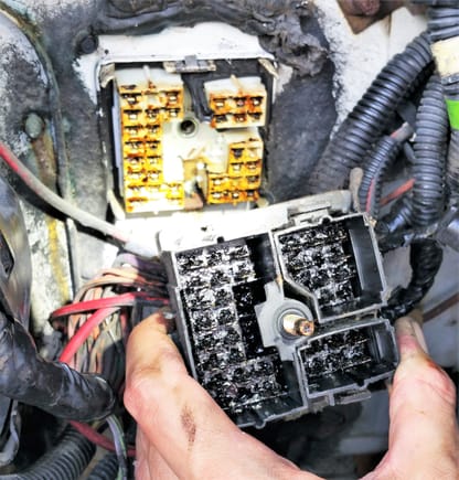 Black gooey mess behind fuse box, looking from engine bay. Under cleaning process at this time.