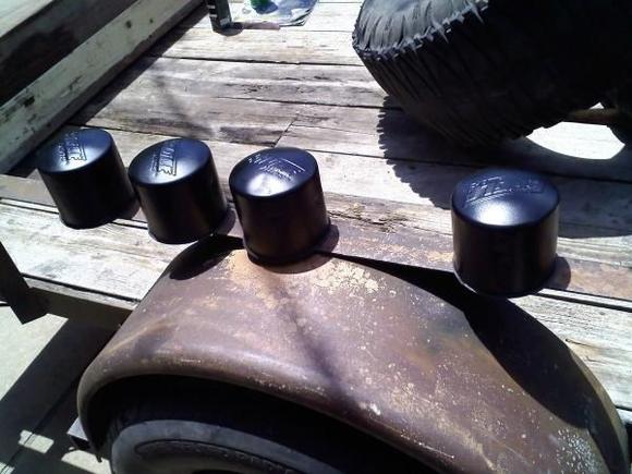 Sanded down old center caps with 80g sandpaper then painted with rust preventing black paint.