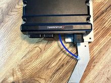 The hole at the lower RH corner of the ECU will mount the master fuse in the power harness.