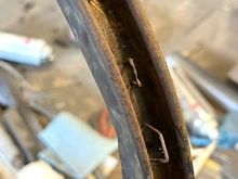 The rear bow had staples driven into the metal to secure the tacking material.  The staples were mostly rusted away at the ends of the bow.