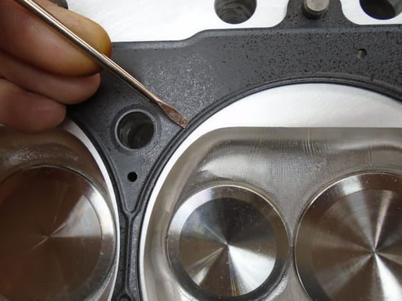4.400" ID MLS head gasket for 4.350" Bore Screwdriver indicating the fire ring / combustion chamber seal