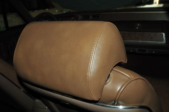 Sewn headrest covers.  No molded-in piping.  Looks more sleek.