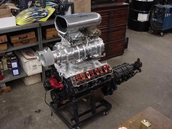 Stole this motor and trans from my '63' rag top [Olds, of course!].  It's a 455 block, bored .070 over, Aries blower pistons, Mondello Heads, steel crank, BDS 8-71 huffer, a couple of holleys and a partridge in a pear tree...  [Sorry. Got carried away...]
Transmission: Old Doug ash 4 1 5 speed