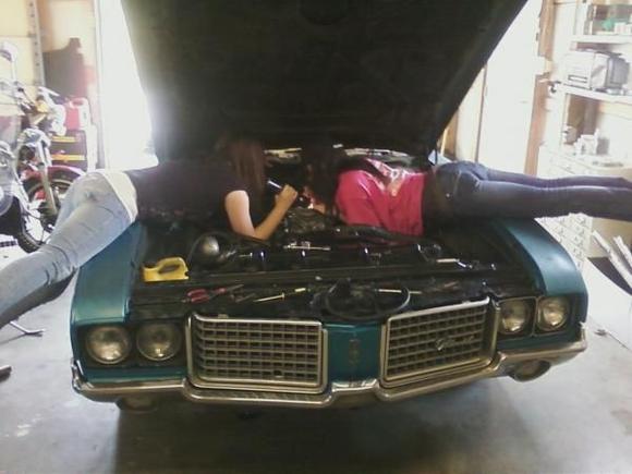 My daughter and friend getting the new Edelbrock package wrapped up on her Supreme