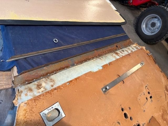 Here I have separated the top piece of steel substructure from the cardboard backer.  Also removed is the interior window belt line seal. 