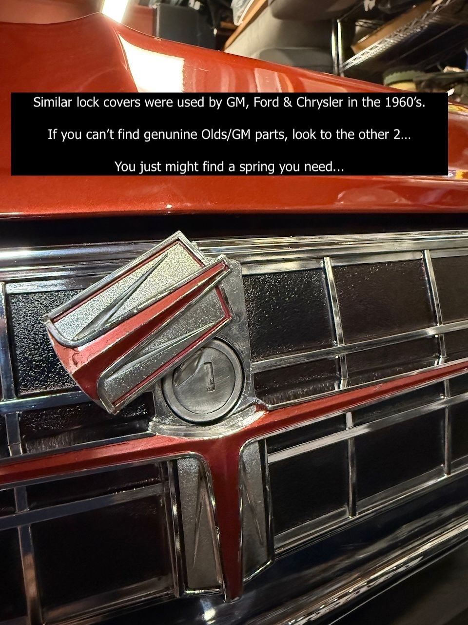 How the trunk lock cover should look open. The cover pivots on a diecast pin and resets itself with a tension spring after use. Eventually the spring can break part of the pin.