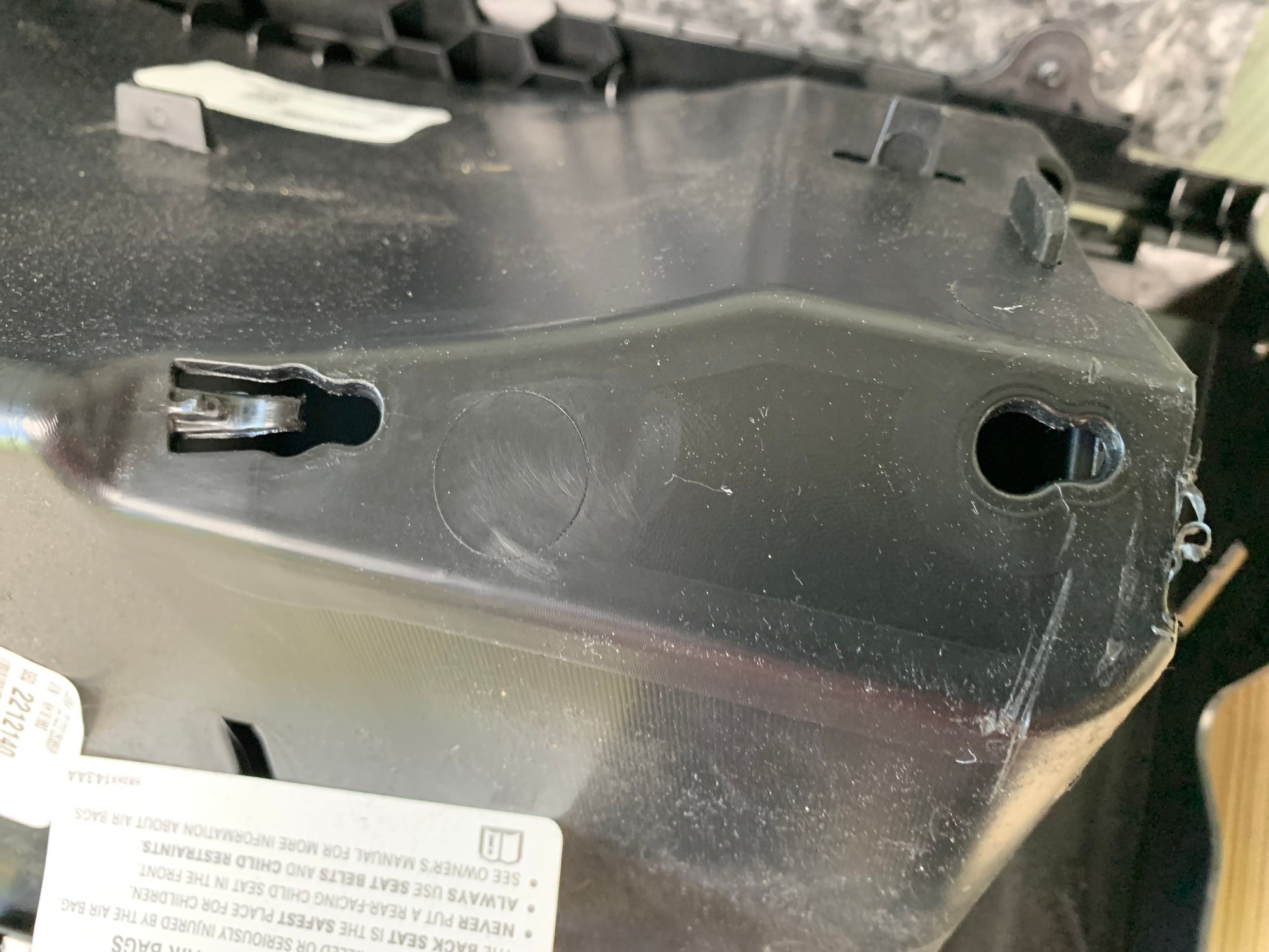 Glove box spring fits into these two holes. Notice one side needs plastic button pushed down, then slide over to lock in place.