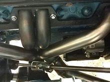 Driver side shot. Its tight with the starter and the steering in place. I know it looks like a bad transition on the exhaust, but its not. Thats a slip fit junction that Im welding up. 