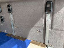 Used some galvanized steel lying around in the garage and the existing holes for the shelf inserts for the mounting brackets. 