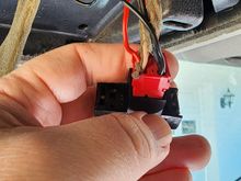 Accessory (added red wire on left) and ground (added black wire on right).  The Acc+ wire supplied with the hardware kit is yellow but I used a slightly larger wire and spade to piggyback with the connector to avoid cutting the original wires.  After wrapping the bundle tightly with self-fusing silicon tape, the connection is reliable.