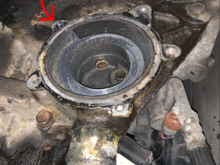 The red arrow points to the bolt that is broken and lodged in the housing. 