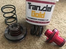 Since Mopar discontinued the rear servo piston spring, I went to a local trans. shop and they hooked me up w/ a new spring! And good thing too bc the replacement A727 trans. spring they had was almost a half inch too short!