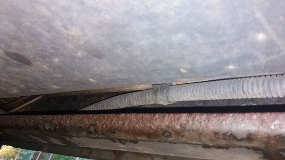 Cant  tell which is brake line....corroded line or metal line?
