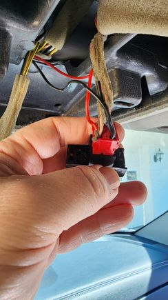 Accessory (added red wire on left) and ground (added black wire on right).  The Acc+ wire supplied with the hardware kit is yellow but I used a slightly larger wire and spade to piggyback with the connector to avoid cutting the original wires.  After wrapping the bundle tightly with self-fusing silicon tape, the connection is reliable.