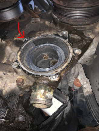 The red arrow points to the bolt that is broken and lodged in the housing. 