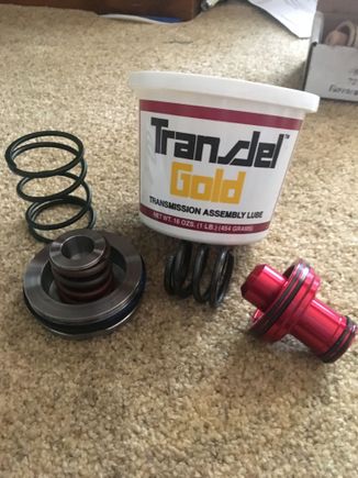 Since Mopar discontinued the rear servo piston spring, I went to a local trans. shop and they hooked me up w/ a new spring! And good thing too bc the replacement A727 trans. spring they had was almost a half inch too short!