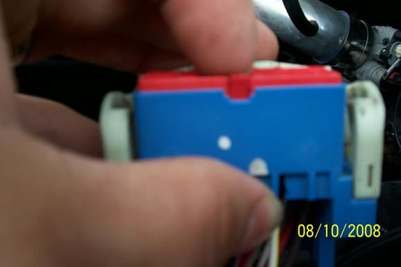 to remove the wire from the grey connector ( i am using the blue because it is all the same) pull out on the red tab. you'll notice that there is an indention on the connector to do so. As you pull out lift up. now the wire lock is released. but you still have to go through the back side with a tooth pick or anything small enough to re lease the wire.