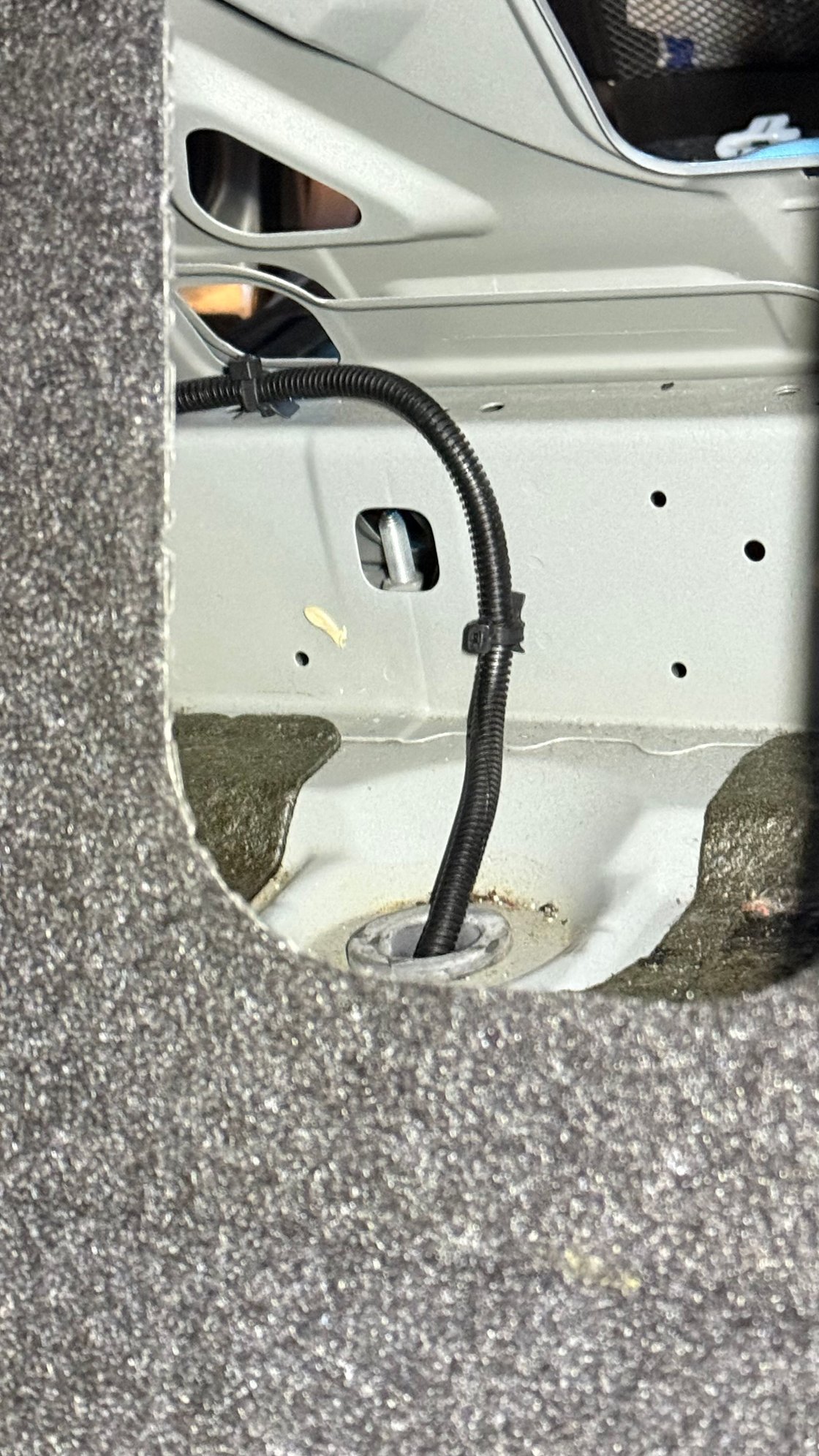 The bolt near by left rear seat area seems causing the squeaky or metallic popping noise, but i couldn�t find no nuts to tighten it� is it the bolt holding gas tank??