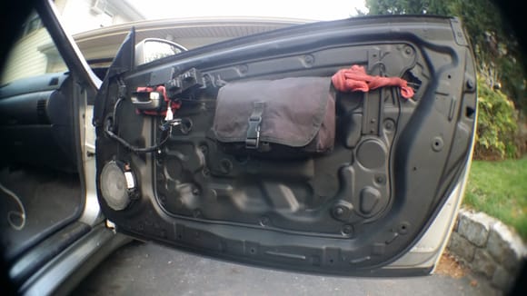 Passenger door stripped, painted. Door handle is temporarily zip-tied in place with a rag to minimize rattling. That saddle bag is just along for the ride right now, taking up space.