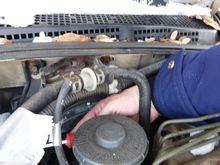 There were many hoses, brackets and connectors attached to the plenum that needed to be removed. Here, I think I was removing a ground cable from a bolt.