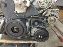 Pulley part # (Dayco) 89161
Belt part # (Dayco) 5060560 (56" belt)

 I actually swapped to a 5060555 (55.5” belt for my AC fittings to clear when I did the ac stuff. It was a 8!+¢4 to get on there.