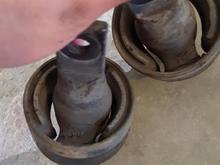 The rubber is worn and torn. It was the reason my car would make squeak noises whenever I go over bumps