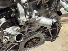 Installed new thermostat, OEM thermostat housing, water outlet.
