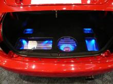 1st generation Polk Momo 10" sub, JL Audio 5 channel amp, Alpine external processor, and Polk Audio crossovers. The compartments are using Varad blue and white LED's. The 5 lug donut spare tire is in the correct location. With the factory trunk liner, everything is hidden and the trunk can still be used normally.