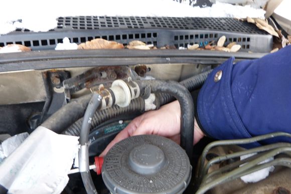 There were many hoses, brackets and connectors attached to the plenum that needed to be removed. Here, I think I was removing a ground cable from a bolt.