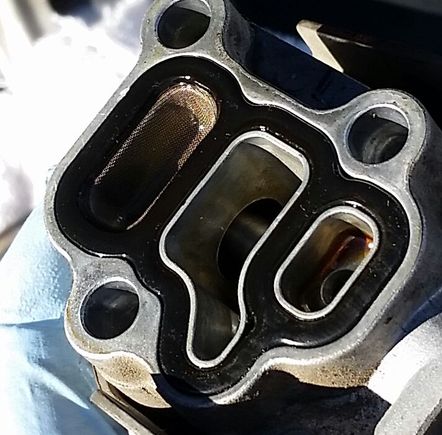 Remove the bolts and pull off the solenoid. My filter looks very healthy. I just wasted $8 on a new filter. Clearly a clogged filter wasn't the cause of the CEL.