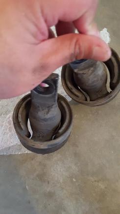 The rubber is worn and torn. It was the reason my car would make squeak noises whenever I go over bumps