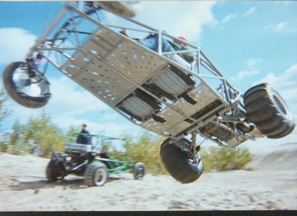 Old Quad 4 powered buggy flying. When you guys get tired of burning up your drivers license on the street try the sand. Go as fast as you want, race all you want, jump off hills all day and it's free. NO COPS, NO RULES, NO STAGING LINES!